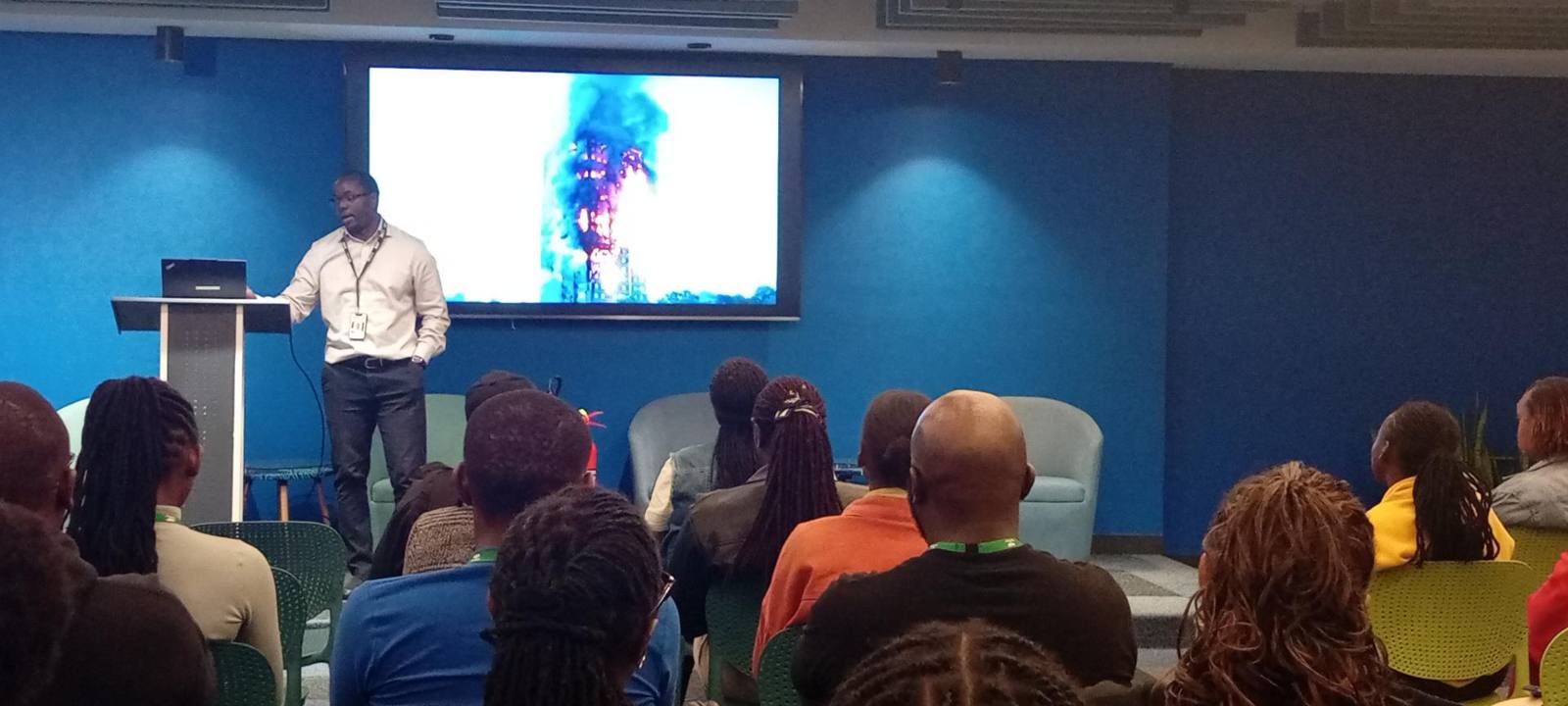 Joshua presenting a fire safety talk to a seated audience